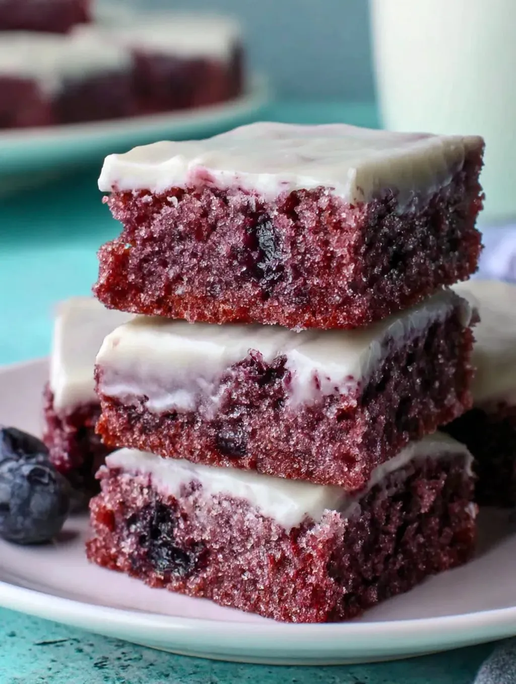 Three pieces of glazed blueberry chewy brownies.