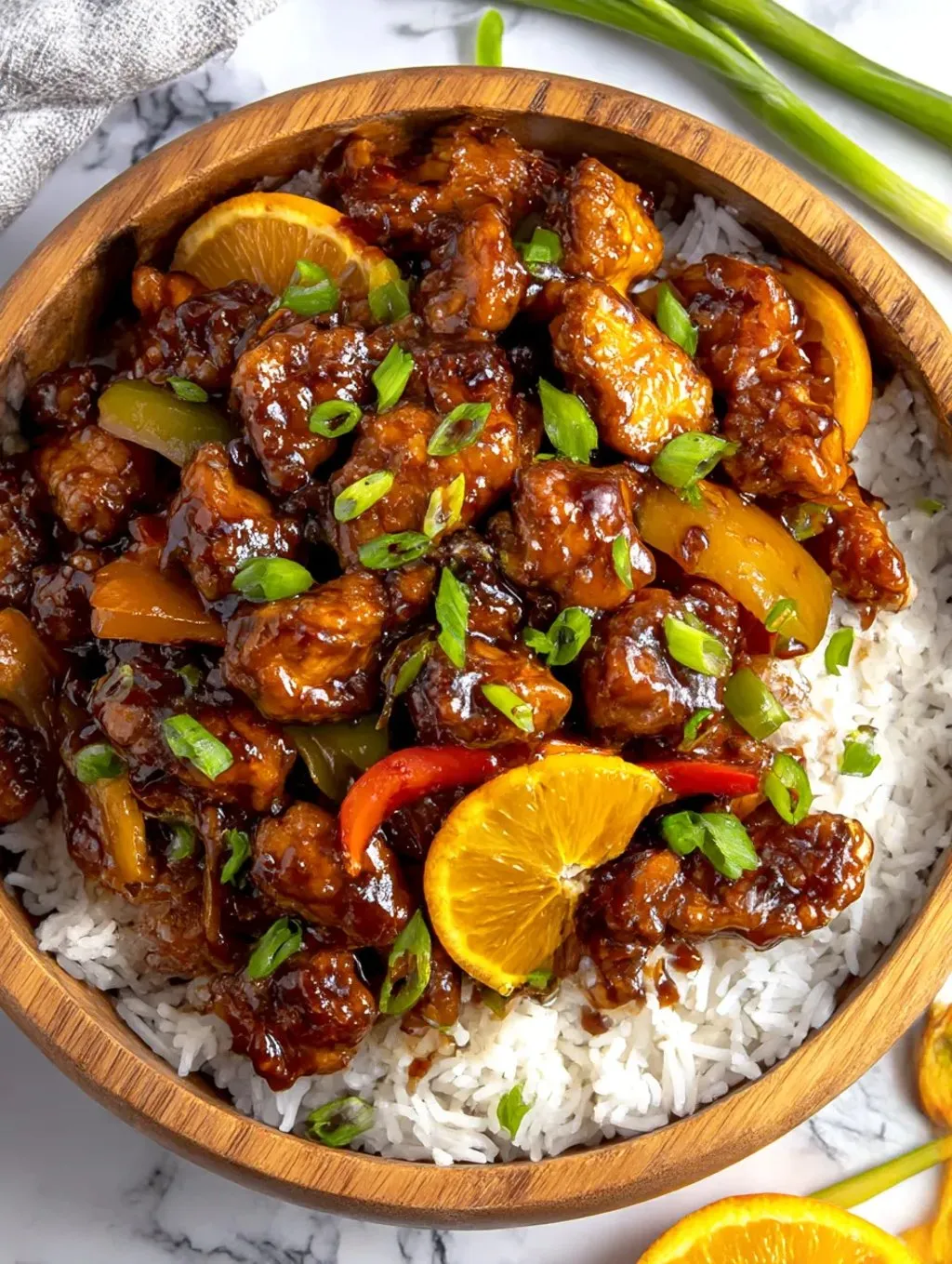 A bowl of juicy blackstone orange chicken.