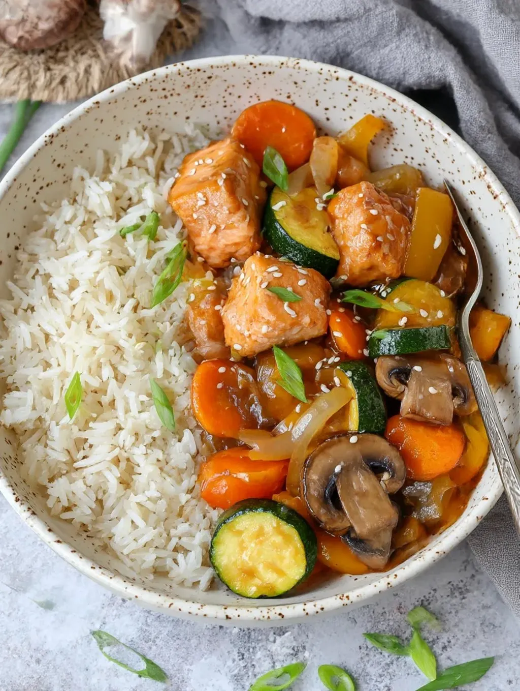 A bowl of stir fry with rice and vegetables.