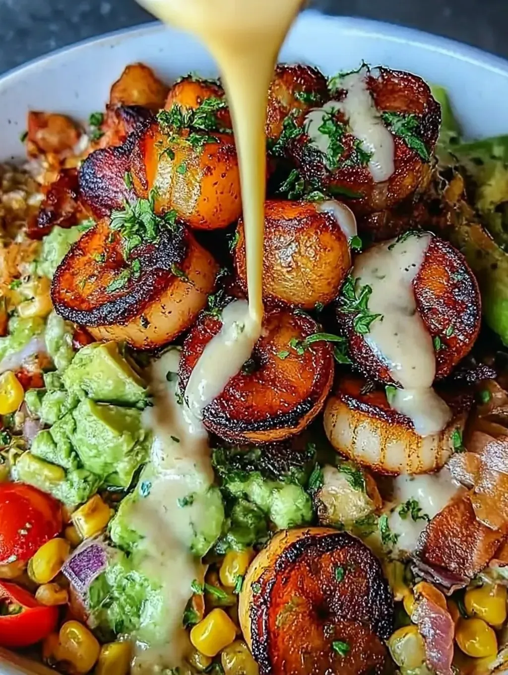 A dish of grilled shrimp, avocado, corn salsa and tomatoes.