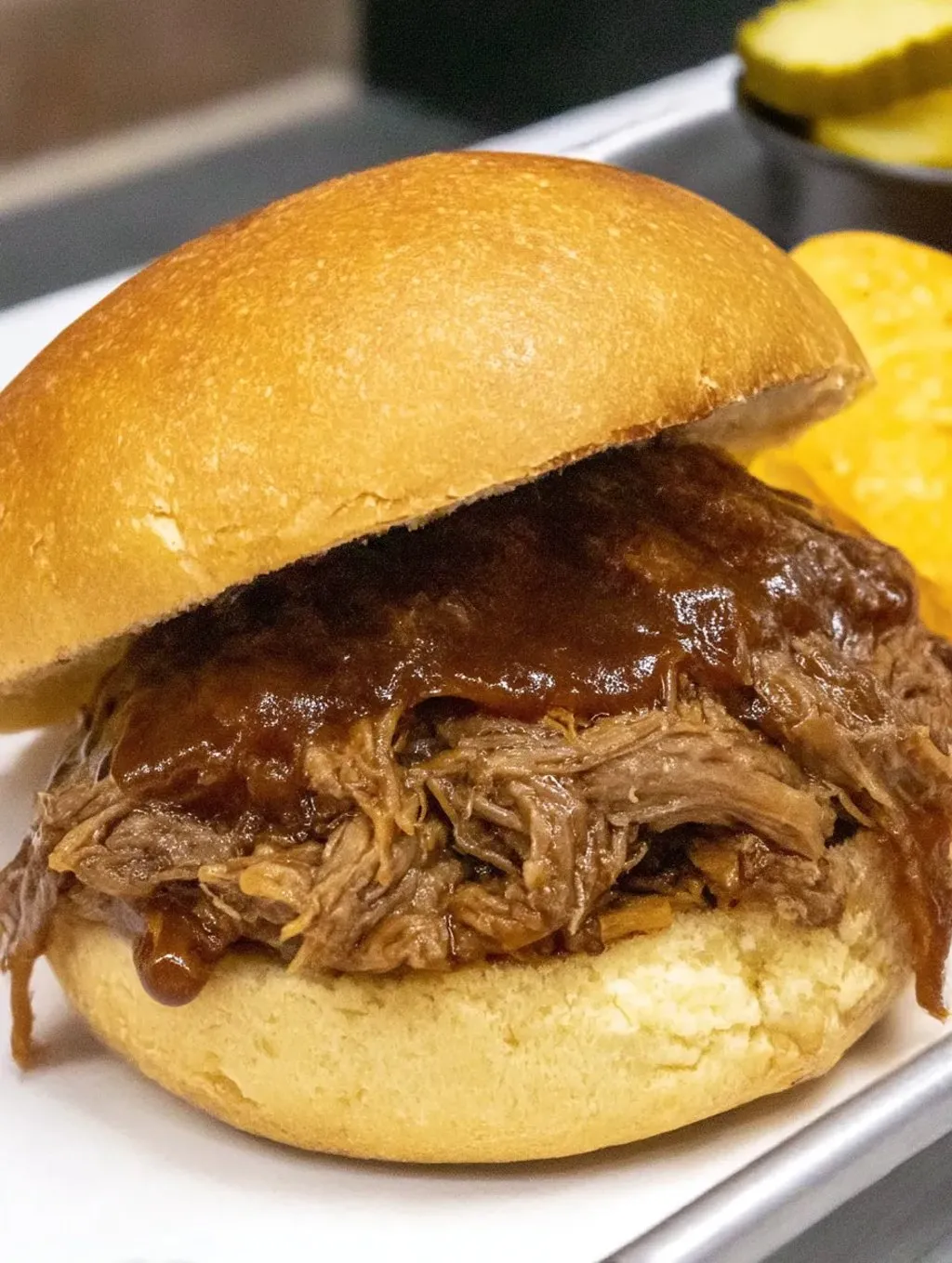 A pulled beef sandwich on a bun.