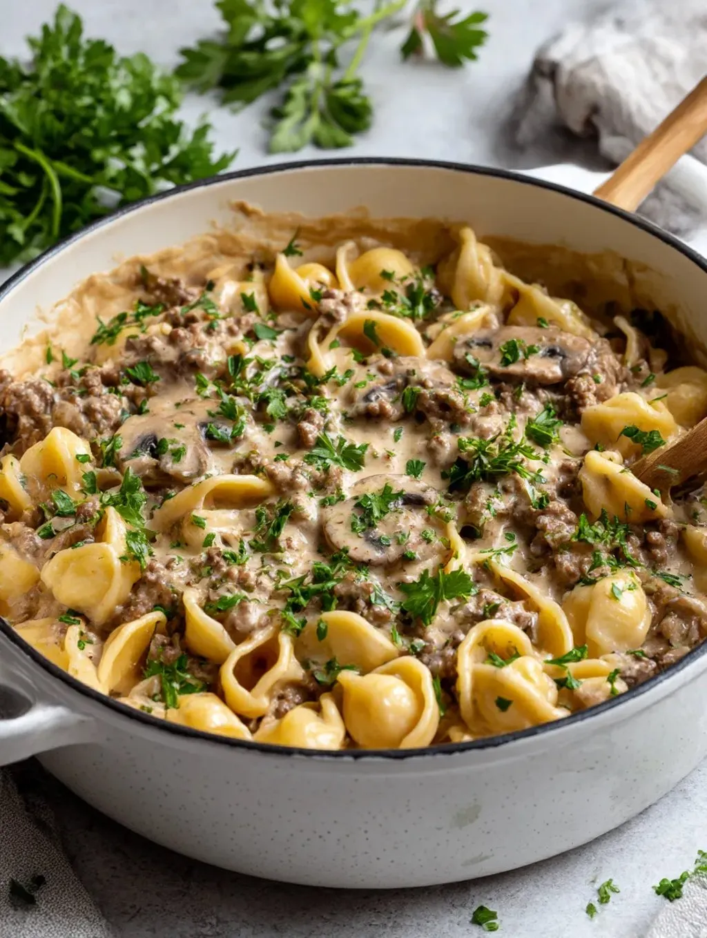 A bowl of food with a wooden spoon in it.
