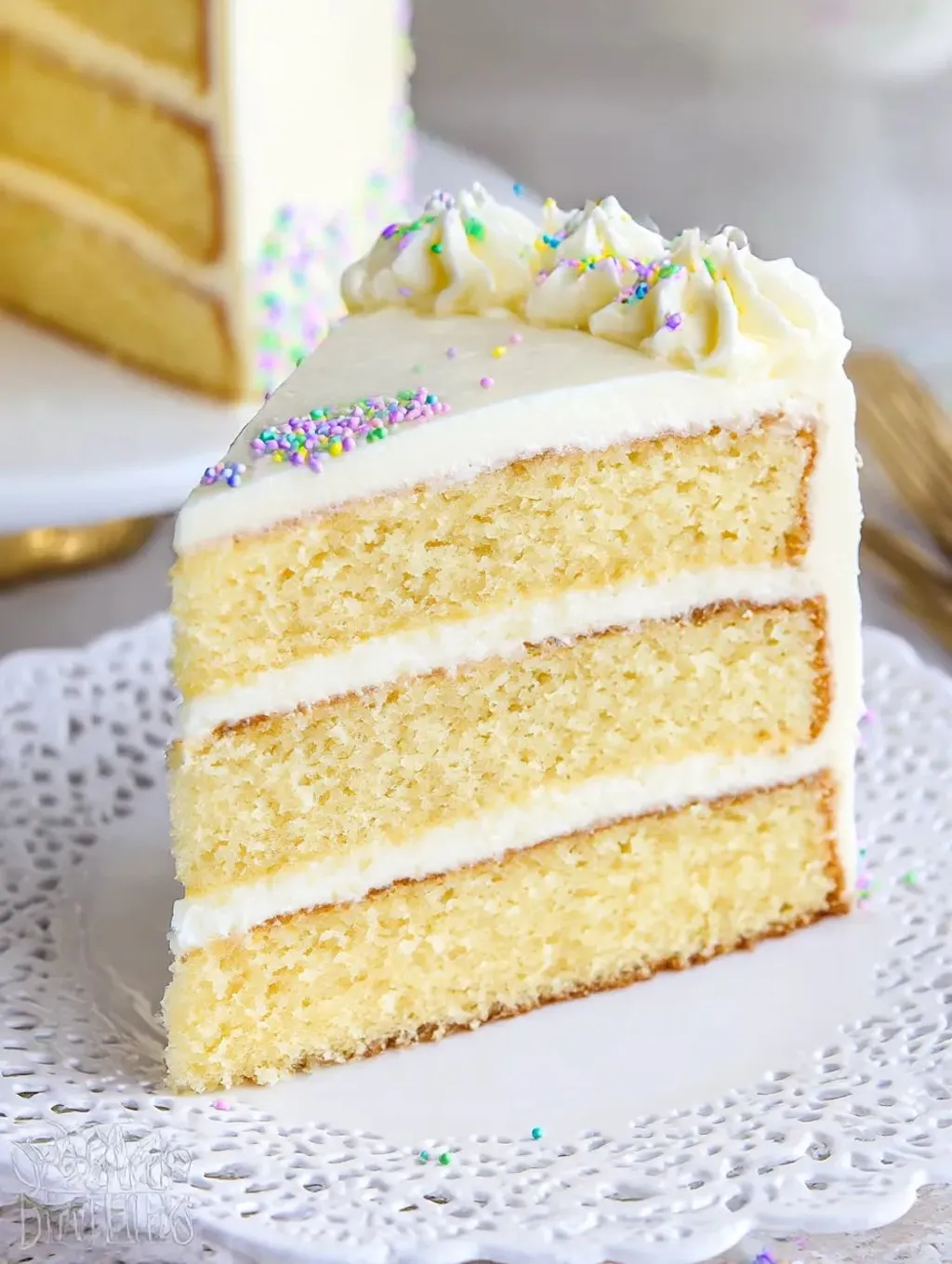 A slice of moist vanilla layer cake.