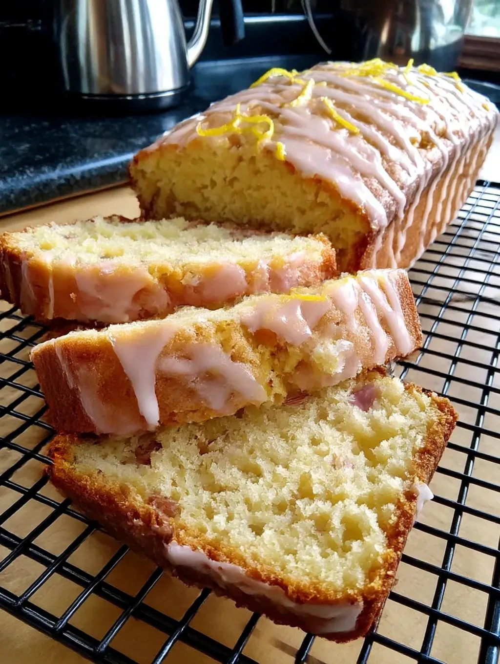 A loaf of lemon rhubarb bread with a glaze.
