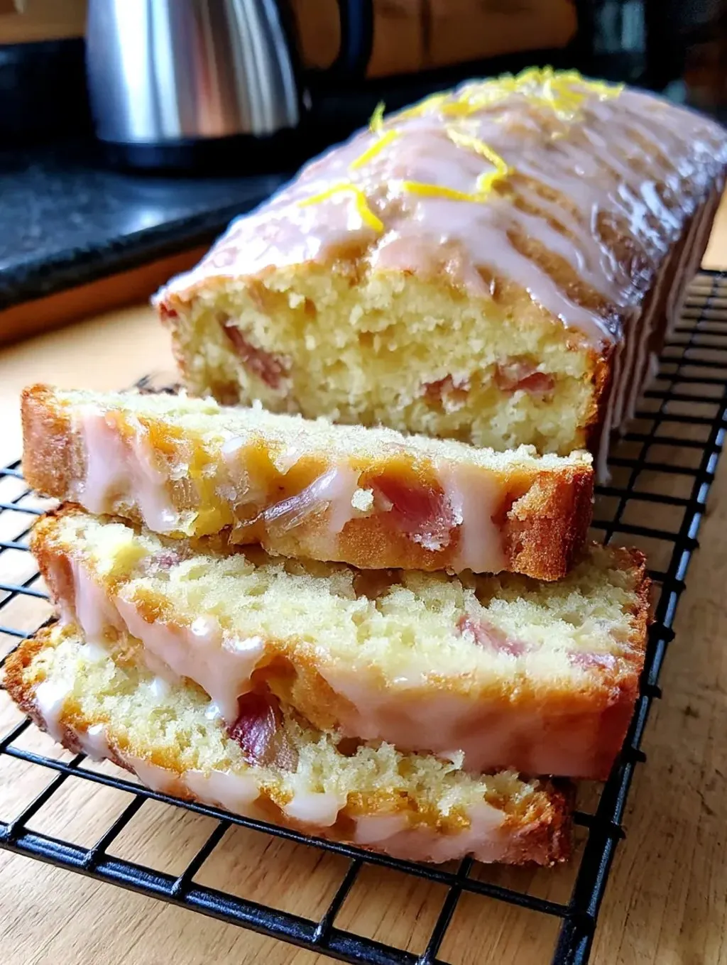 A loaf of lemon rhubarb bread with a glaze.