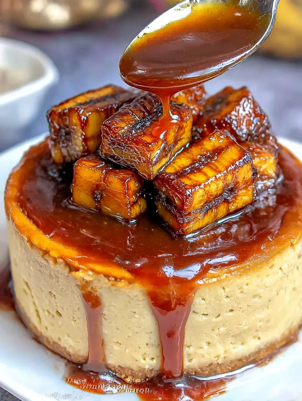 A slice of caramelized banana cheesecake with a rum glaze.
