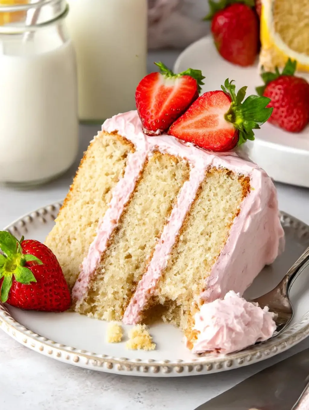 A slice of strawberry lemon cake on a plate.