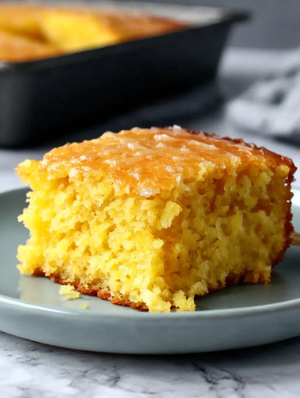 A slice of lemon cake on a plate.