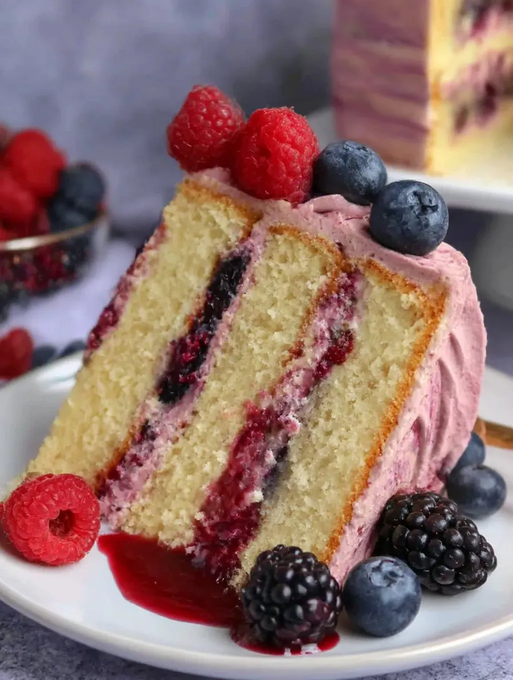 A slice of berry cake on a plate.