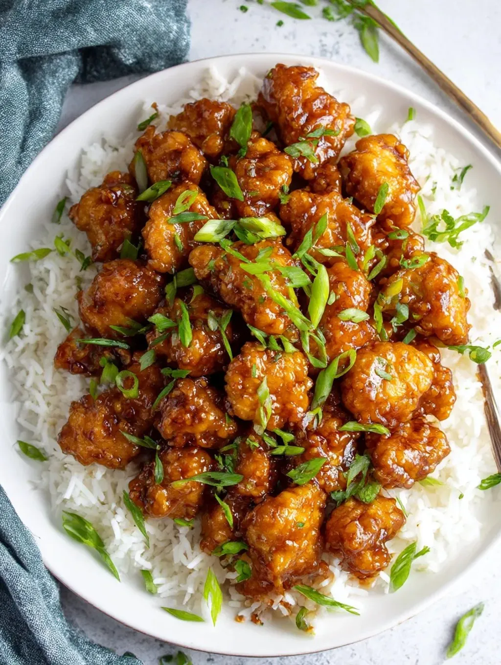 A plate of rice and chicken with a fork on the side.