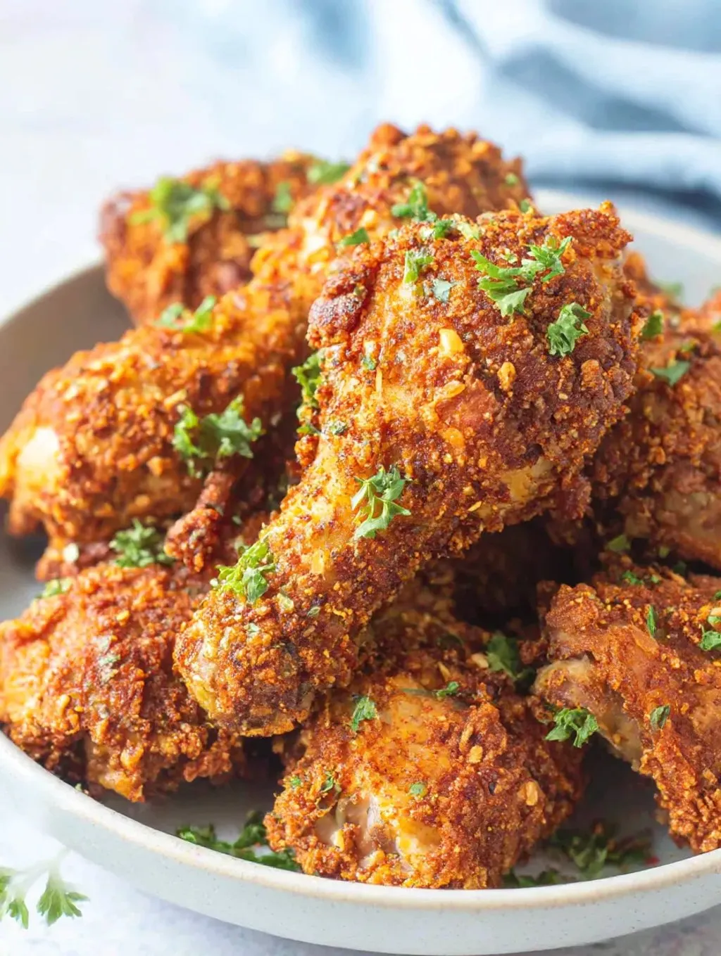 A bowl of chicken with greens.