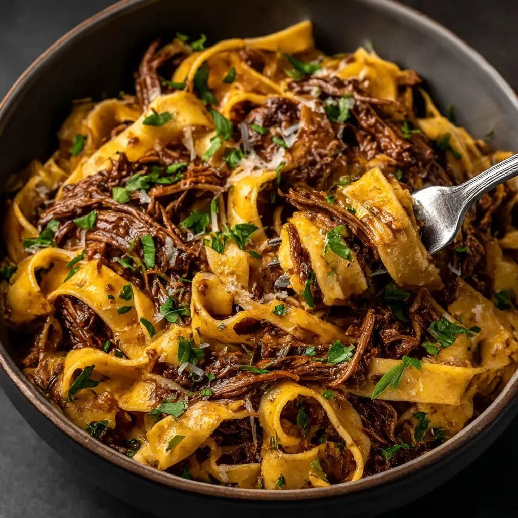 A bowl of pasta with meat and cheese.