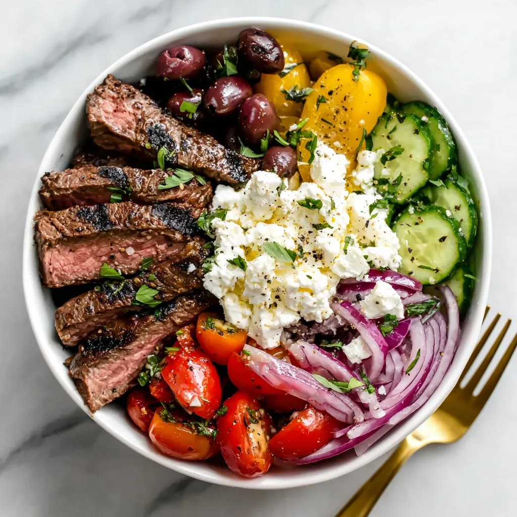 A bowl of food with meat, tomatoes, cucumbers, and cheese.