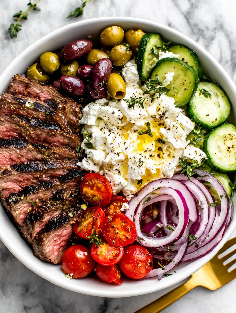 A bowl of food with meat, vegetables, and cheese.