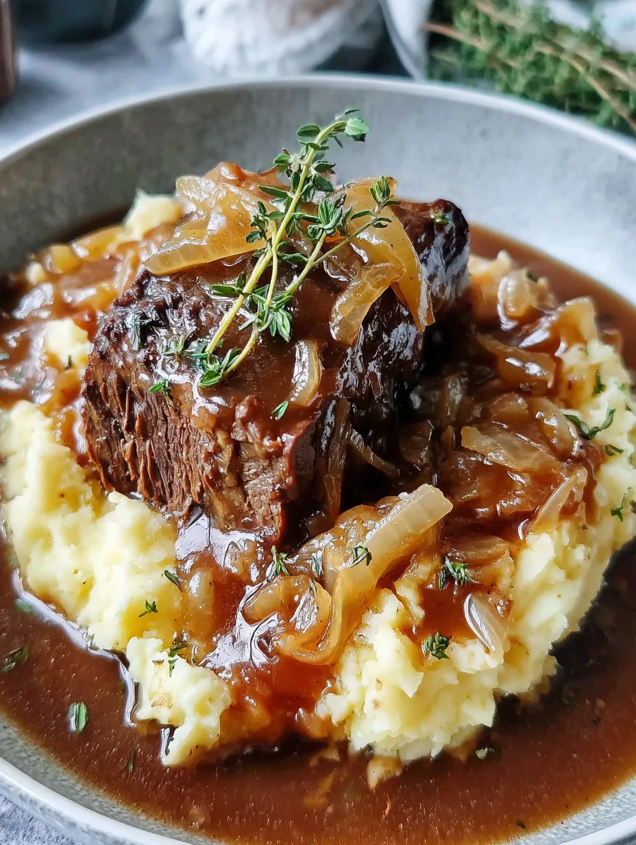 A plate of food with meat and onions.