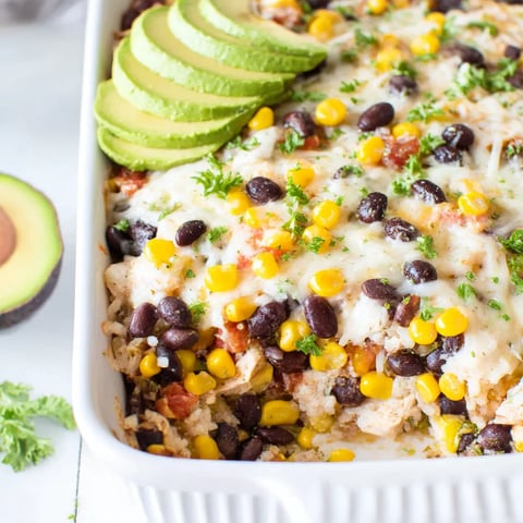 A dish with a variety of ingredients including corn, beans, and avocado.